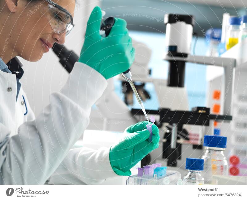 Biotech Research, Scientist pipetting sample into a vial ready for analysis during a experiment in the laboratory liquids controlling protect protecting safe