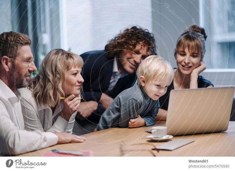 Business team with boy looking at laptop in office colleague Occupation Work job jobs profession professional occupation superior supervisor the boss