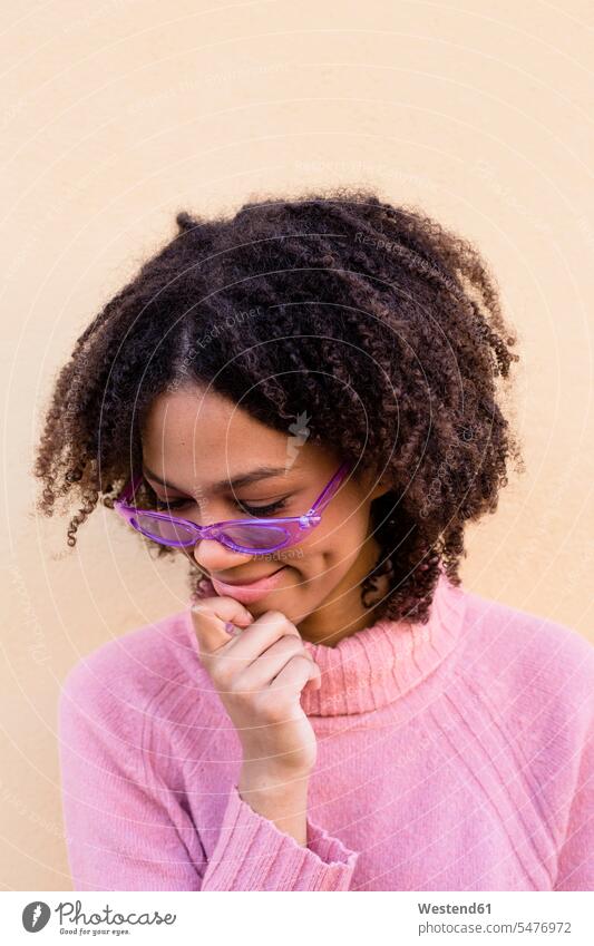 Portrait of smiling young woman wearing pink pullover and purple sunglasses sweater jumper Sweaters females women portrait portraits Rosy sun glasses