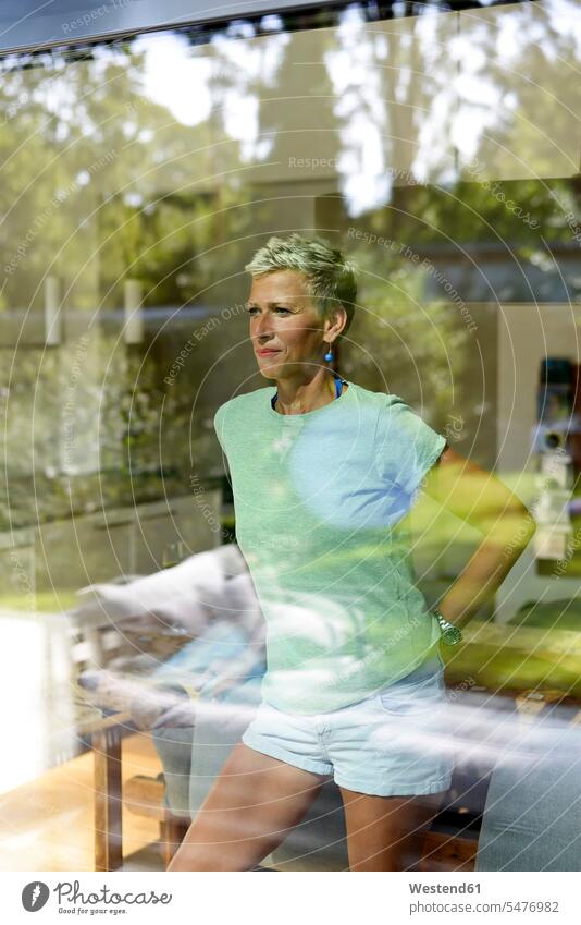 Portrait of woman with short hair looking out of window females women windows cropped hair shorthaired short-haired view seeing viewing Adults grown-ups