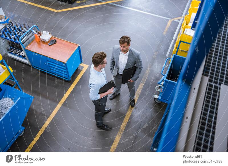 Top view of two businessmen talking in factory Occupation Work job jobs profession professional occupation business life business world business person