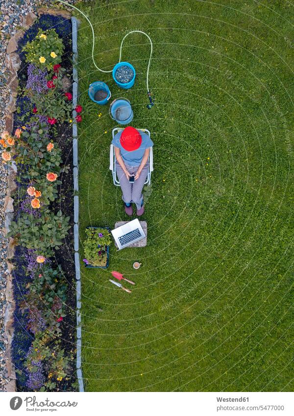 Aerial view of woman sitting in garden human human being human beings humans person persons caucasian appearance caucasian ethnicity european 1 one person only