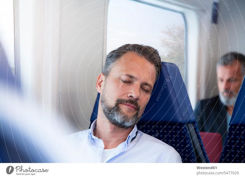 Mature man sitting in a train, sleeping human human being human beings humans person persons caucasian appearance caucasian ethnicity european 2 2 people