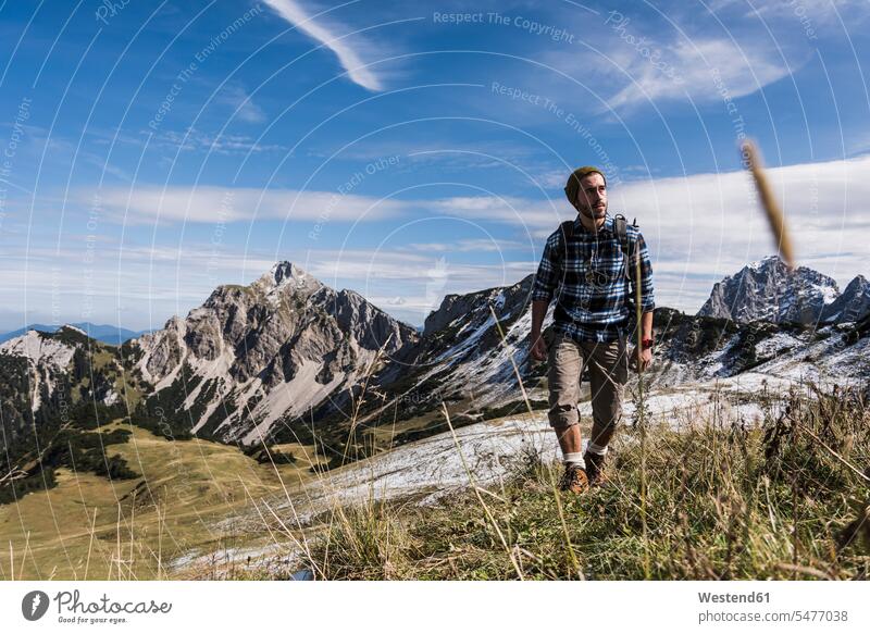 Austria, Tyrol, young man hiking in the mountains men males mountain range mountain ranges hike mountainscape mountainscapes mountain scenery Mountainous Region