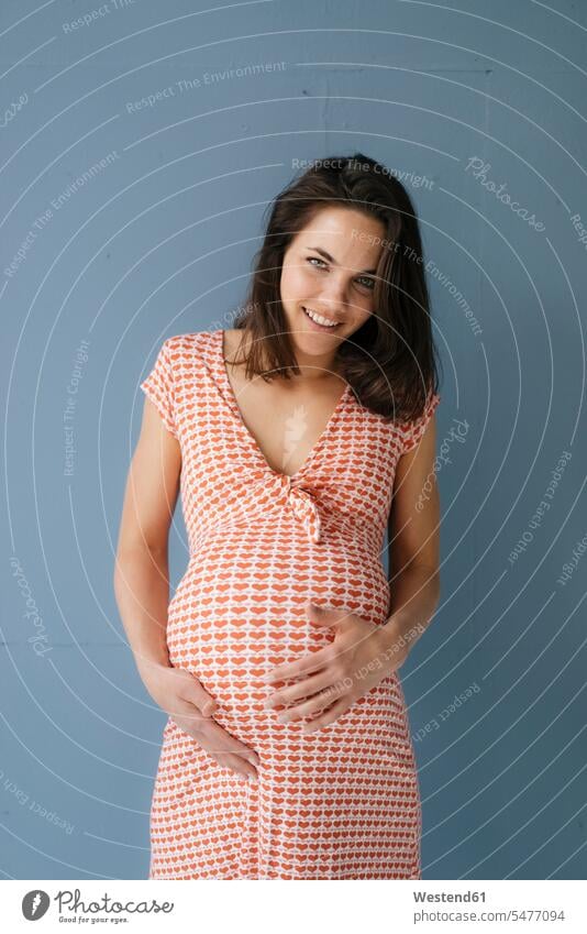 Woman pretending to be pregnant, touching belly mid adult women mid adult woman mid-adult women mid-adult woman Pregnant Woman stroking petting bellies abdomen