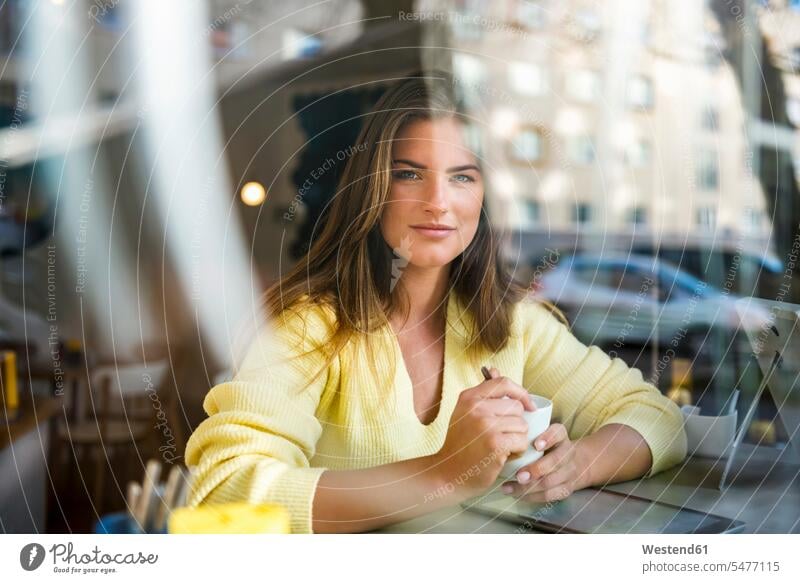 Portrait of smiling young woman in a cafe portrait portraits smile females women Adults grown-ups grownups adult people persons human being humans human beings