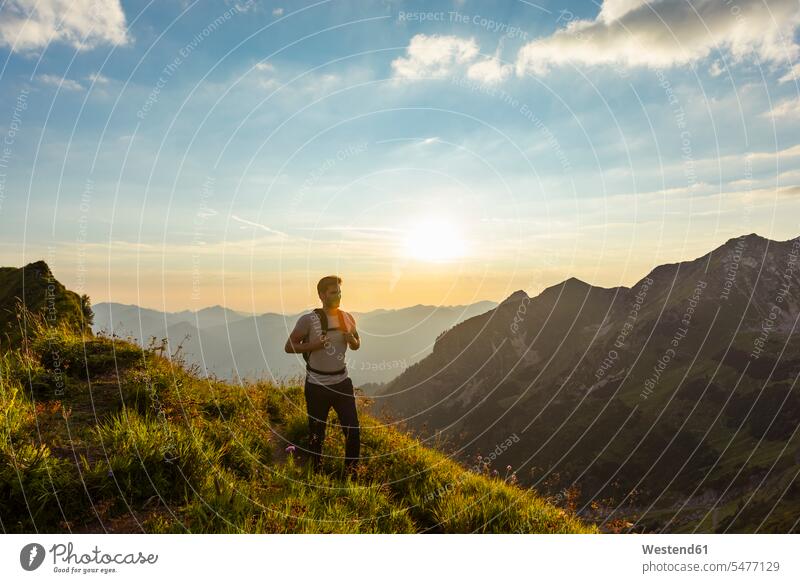 Germany, Bavaria, Oberstdorf, man on a hike in the mountains at sunset men males sunsets sundown hiking mountainscape mountainscapes mountain scenery
