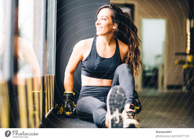 Smiling female boxer resting after boxing training windows exercise practising smile Seated sit delight enjoyment Pleasant pleasure happy Contented Emotion