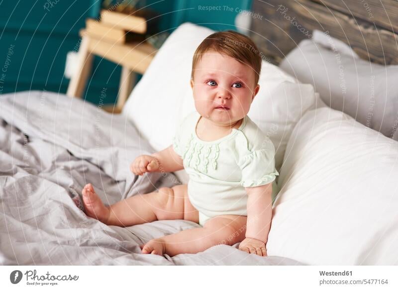 Sad baby crying on bed at home beds sad infants nurselings babies Emotion Feeling Feelings Sentiments Emotions emotional people persons human being humans