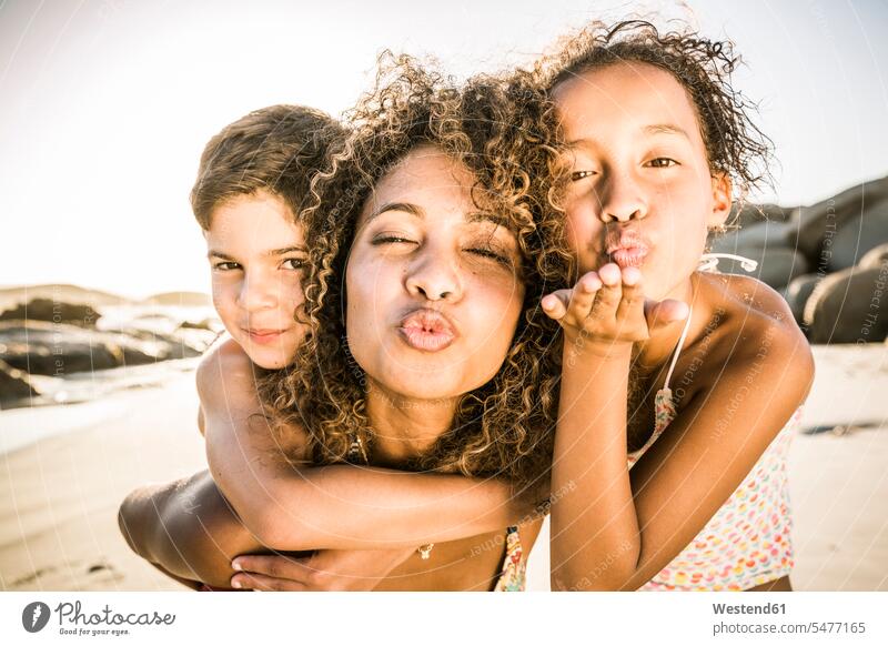 Portrait of a mother with her two kids having fun on the beach human human being human beings humans person persons Mixed Race mixed race ethnicity