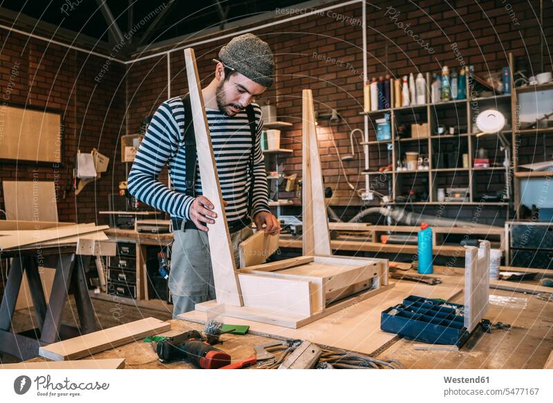 Carpenter working on wooden table human human being human beings humans person persons caucasian appearance caucasian ethnicity european 1 one person only