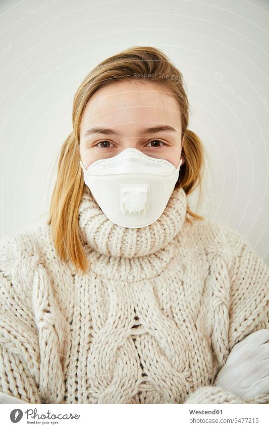 Portrait of blond woman wearing FFP2 mask at home jumper sweater Sweaters healthy hygienic Hygienics protect protecting safe Safety secure dangerous portraits
