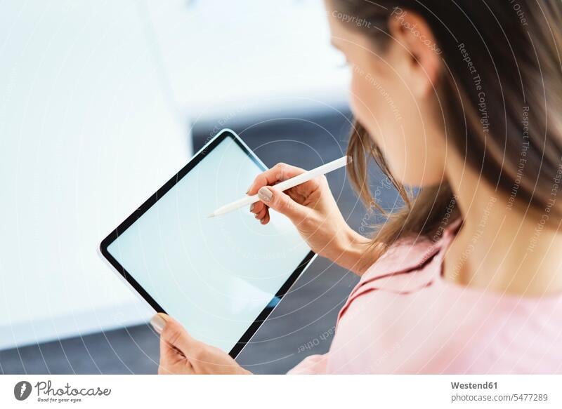 Over the shoulder view of woman drawing on tablet using pencil human human being human beings humans person persons caucasian appearance caucasian ethnicity