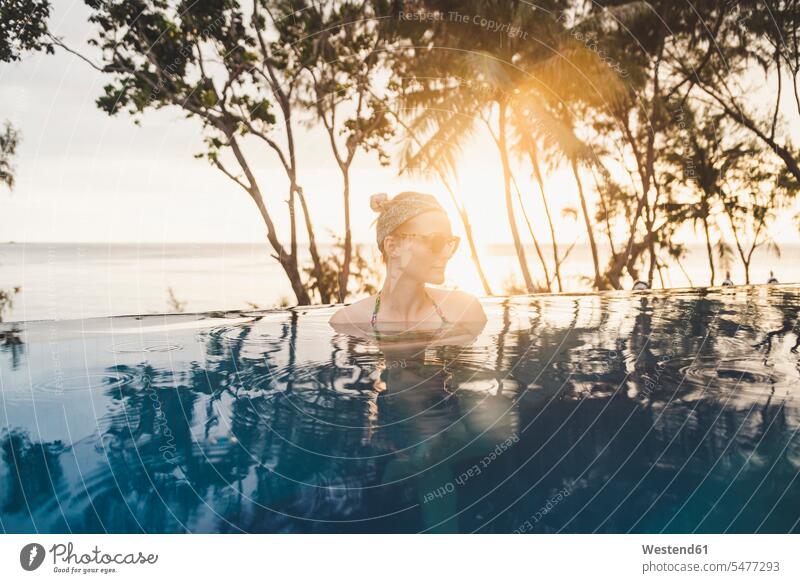 Woman in infinity pool at sunset, Nai Thon Beach, Phuket, Thailand Eye Glasses Eyeglasses specs spectacles Pair Of Sunglasses sun glasses bathe Taking A Bath