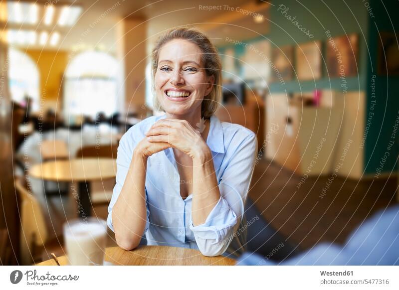 Portrait of happy woman in a cafe happiness females women portrait portraits Adults grown-ups grownups adult people persons human being humans human beings
