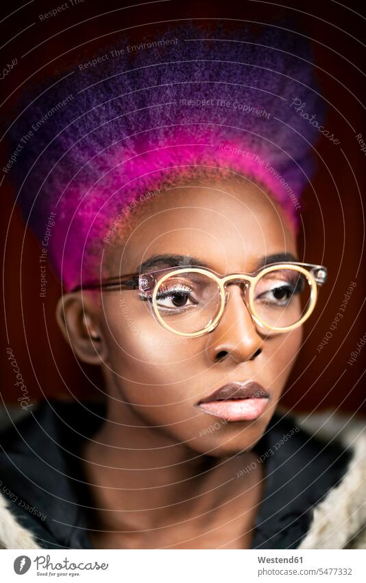 Portrait of young woman with pink and purple dyed hair wearing fashionable glasses magenta portrait portraits females women specs Eye Glasses spectacles