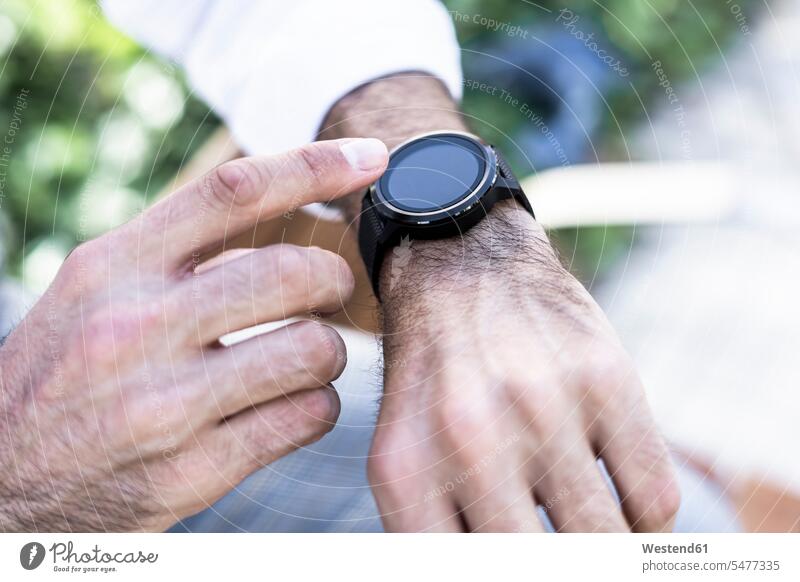 Close-up of man using smartwatch outdoors men males smart watch Adults grown-ups grownups adult people persons human being humans human beings awaiting