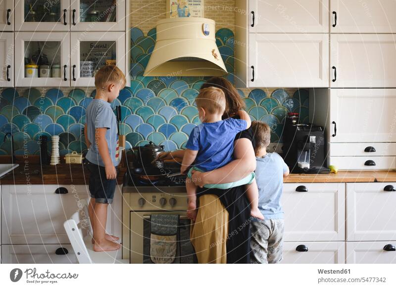 Mother cooking with her three sons in the kitchen human human being human beings humans person persons caucasian appearance caucasian ethnicity european Group
