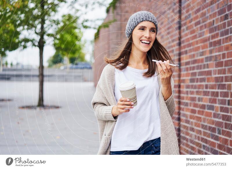 Portrait of happy woman with coffee to go on the phone happiness Coffee to Go takeaway coffee females women takeaway drink Drink beverages Drinks Beverage