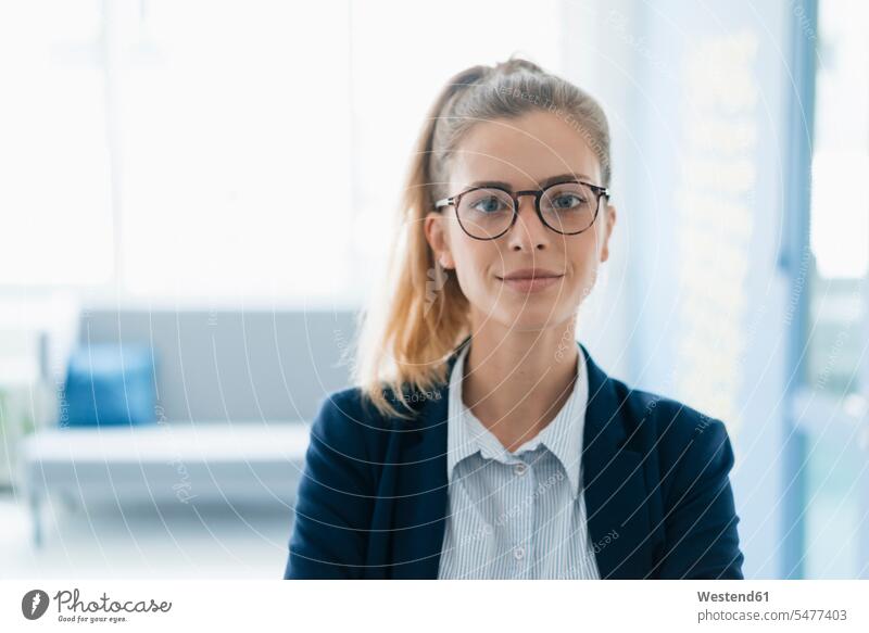 Portrait of a confident young businesswoman, standing in office Dedication Engagement dedicated Eager Input eagerness Commitment Ambition ambitious confidence
