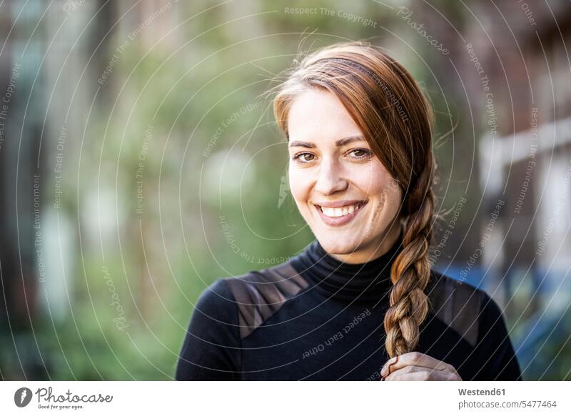Portrait of smiling woman with braid braids plait plaits portrait portraits smile females women hairstyle hair-dos hairstyles hairdos people persons human being