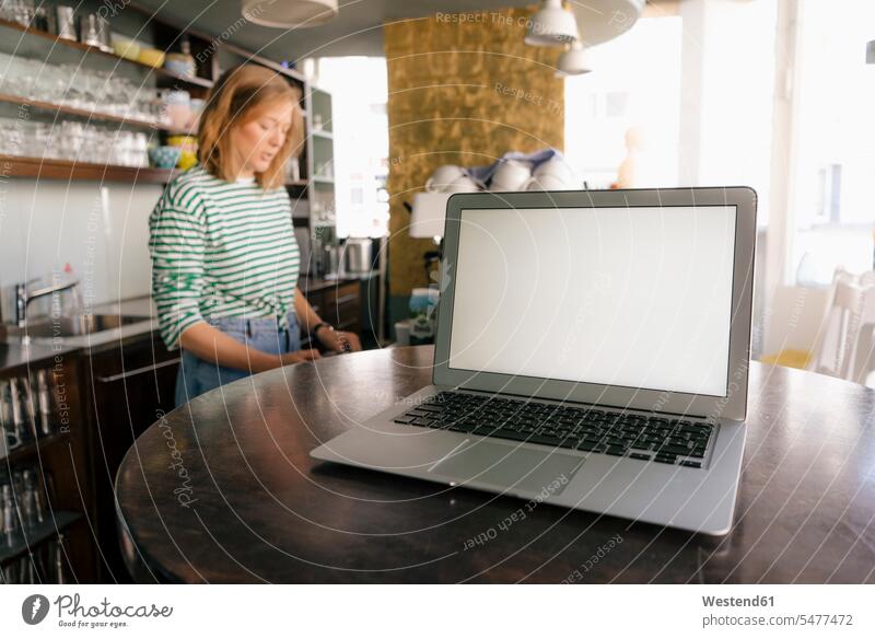 Laptop and woman in a cafe females women laptop Laptop Computers laptops notebook Adults grown-ups grownups adult people persons human being humans human beings