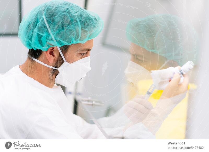 Close-up of male pharmacist making medicines in laboratory color image colour image Spain indoors indoor shot indoor shots interior interior view Interiors