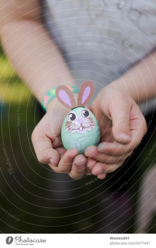 Close-up of girl holding decorated Easter egg spring season Spring Time springtime free time leisure time Humor Humorous Ideas creative funny having fun