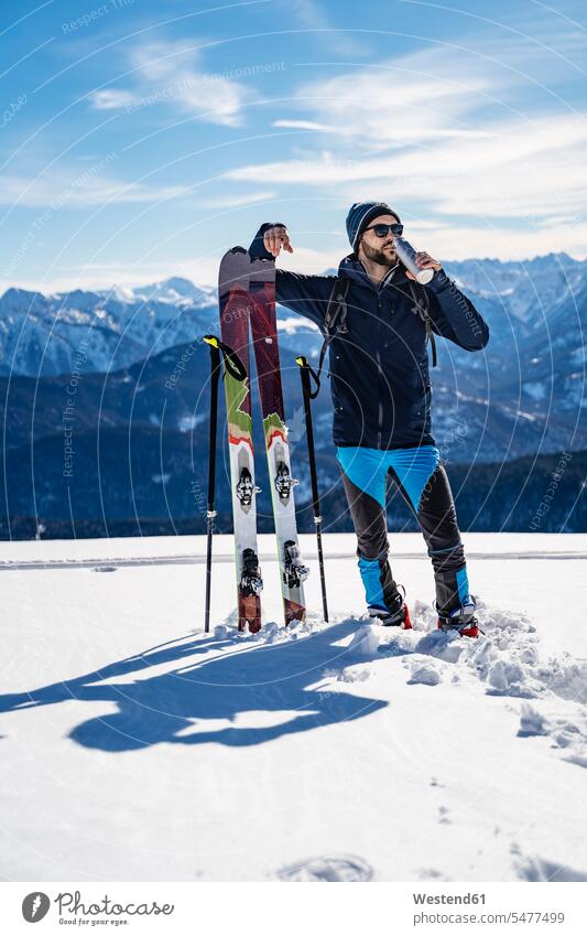 Germany, Bavaria, Brauneck, man on a ski tour in winter in the mountains having a break men males hibernal Ski Touring ski tours Adults grown-ups grownups adult