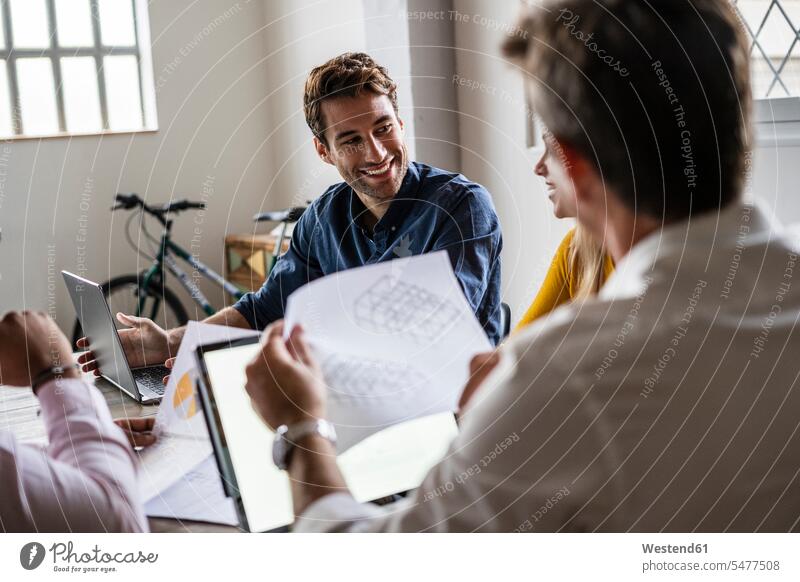 Confident business team having a meeting in loft office offices office room office rooms business world business life Business Meeting business conference lofts