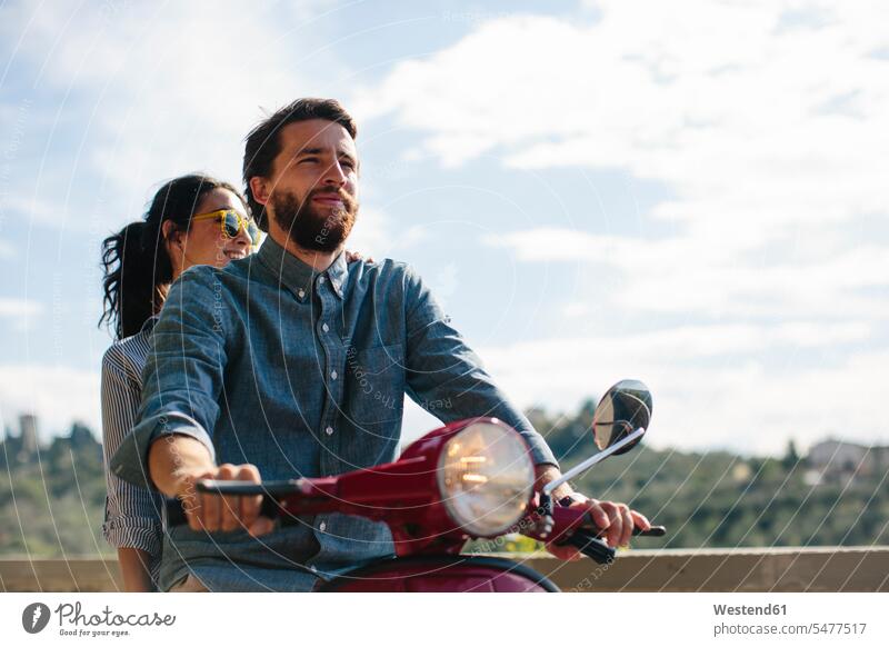 Couple on Vespa against sky color image colour image Tuscany Italy tourism touristic leisure activity leisure activities free time leisure time casual clothing