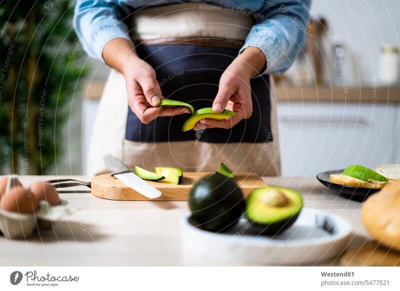 Mid section of woman peeling avocados indoors indoor shot indoor shots interior interior view Interiors day daylight shot daylight shots day shots daytime