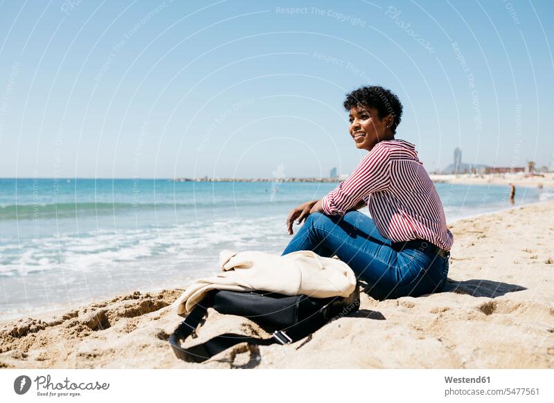 Woman sitting on the beach enjoying the sun after work human human being human beings humans person persons Mixed Race mixed race ethnicity mixed-race Person 1