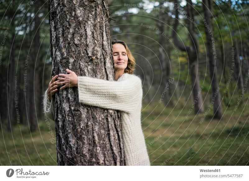 Woman hugging tree in forest relaxation relaxing Tree Trunk Tree Trunks getting away from it all Getting Away From All unwinding Tree Hugging clutching woods
