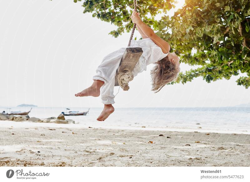 Thailand, Phi Phi Islands, Ko Phi Phi, little girl on a rope swing on the beach ropes swing set playground swing swingset beaches swinging rock rocking females