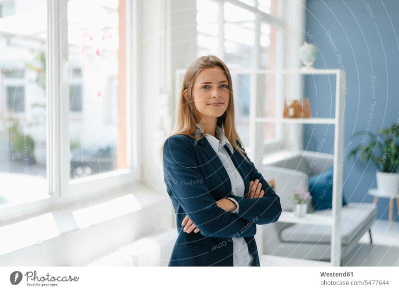 Portrait of a confident young businesswoman, standing in office arms crossed Arms Folded Folded Arms Crossed Arms Crossing Arms Arms Clasped confidence portrait