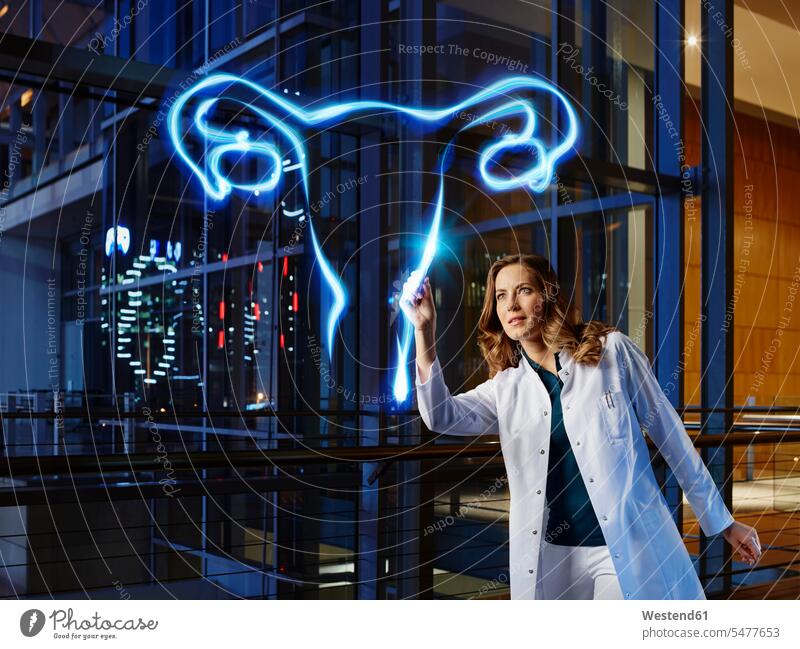 Female gynecologist light painting ovary in laboratory at hospital color image colour image indoors indoor shot indoor shots interior interior view Interiors