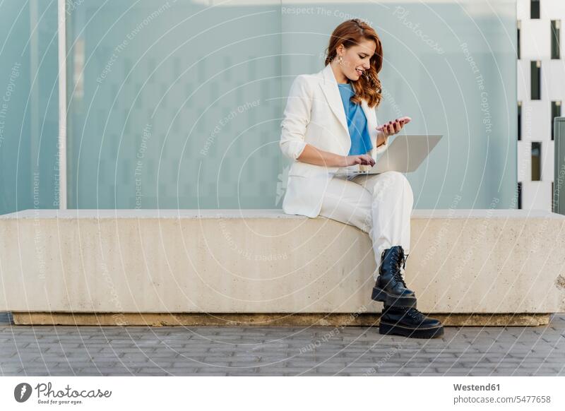 Businesswoman in white pant suit, sitting on bench, using laptop Occupation Work job jobs profession professional occupation business life business world
