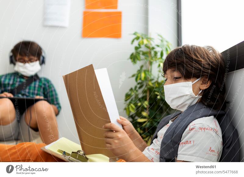 Boys wearing masks studying while sitting at distance in school color image colour image Spain 10-11 years 10 to 11 years children kid kids people human being