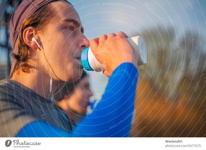Two teenagers drinking water after a run human human being human beings humans person persons caucasian appearance caucasian ethnicity european 2 2 people