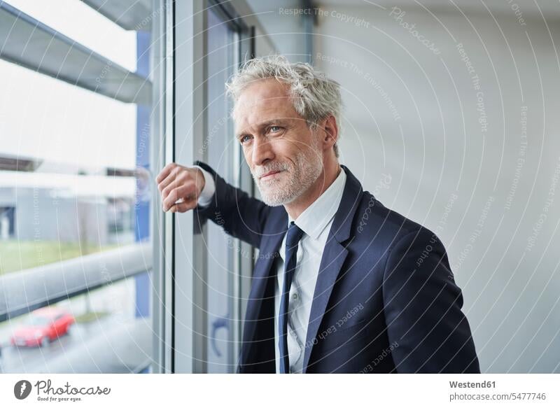 Portrait of confident businessman looking out of window Occupation Work job jobs profession professional occupation business life business world business person