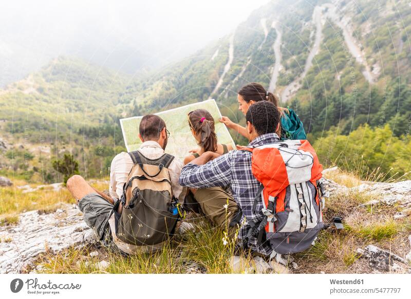 Italy, Massa, group of people hiking and looking at a map in the Alpi Apuane friends mate maps sitting Seated mountain mountains mountain range mountain ranges