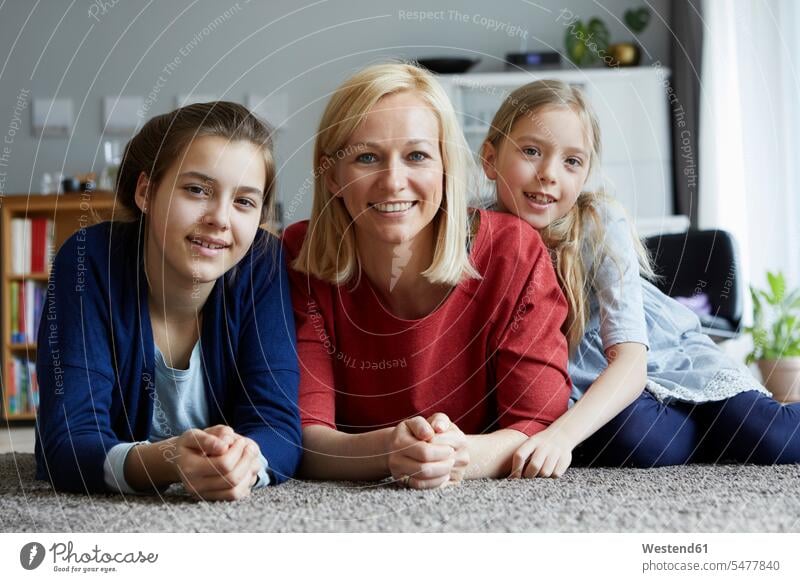 Happy mother and daughters having fun at home Floor Floors mommy mothers ma mummy mama happiness happy lying laying down lie lying down floor floors child