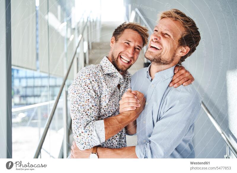Portrait of two happy young businessmen shaking hands human human being human beings humans person persons 2 2 people 2 persons two persons adult grown-up