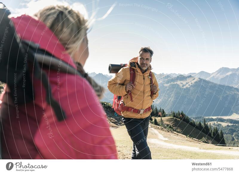 Austria, Tyrol, man with woman hiking in the mountains couple twosomes partnership couples men males hike mountain range mountain ranges people persons