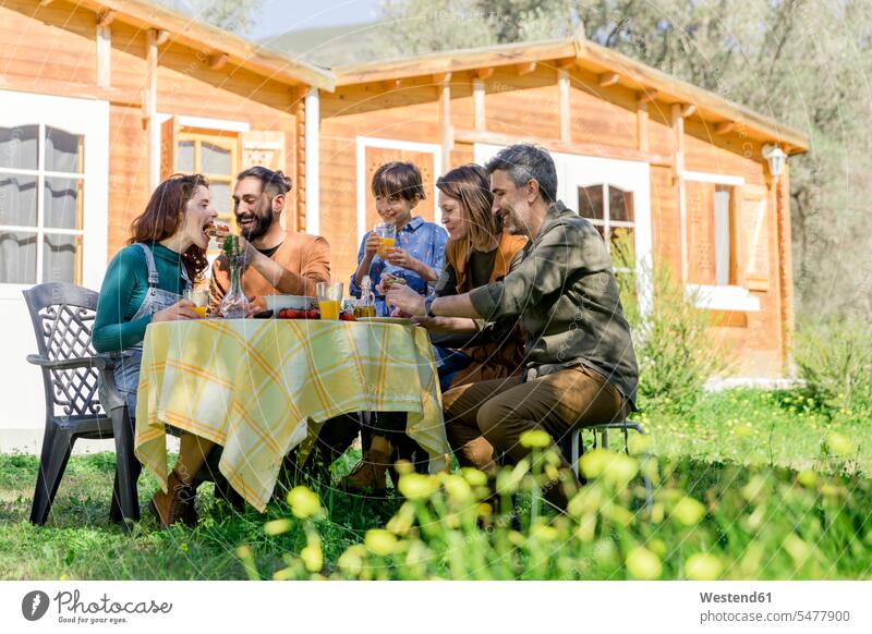 Family and friends enjoying a healthy vegan breakfast in the countryside human human being human beings humans person persons caucasian appearance
