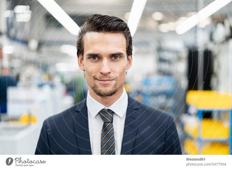 Portrait of confident businessman in a factory confidence Businessman Business man Businessmen Business men portrait portraits factories business people