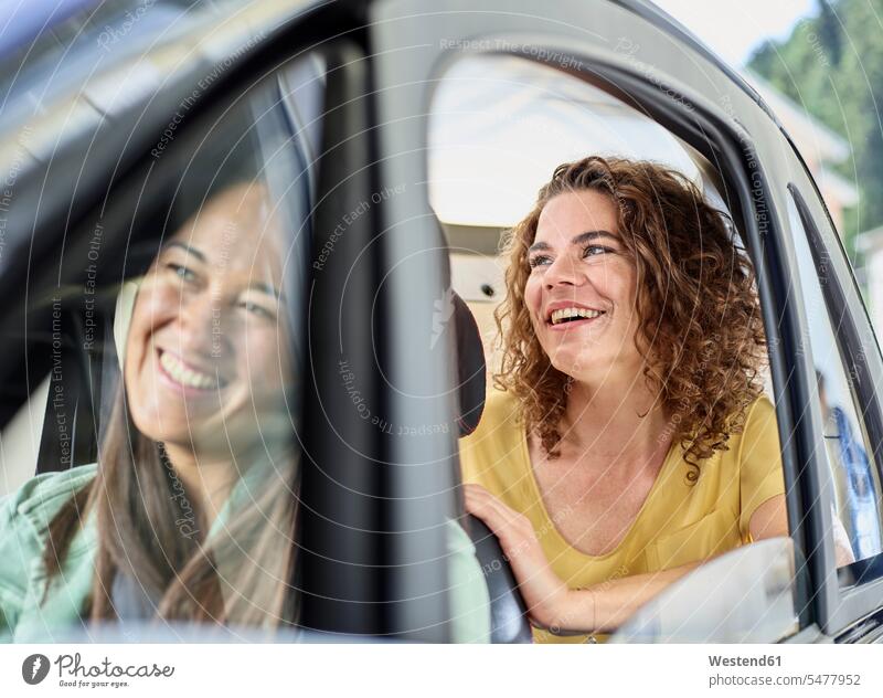 Two happy women in electric bubble car electric car automobile Auto cars motorcars Automobiles happiness woman females electric vehicle electric vehicles