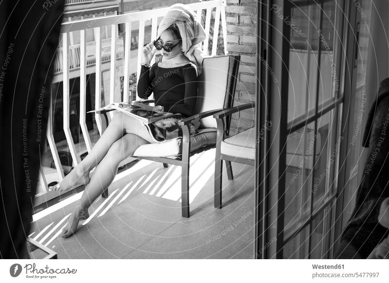 Glamour lady reading a magazine on balcony, hand on glasses windows towels journal journals magazines dresses chairs Eye Glasses Eyeglasses specs spectacles