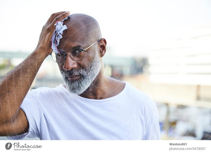 Portrait of mature man wiping his bald on hot summer day human human being human beings humans person persons Mixed Race mixed race ethnicity mixed-race Person
